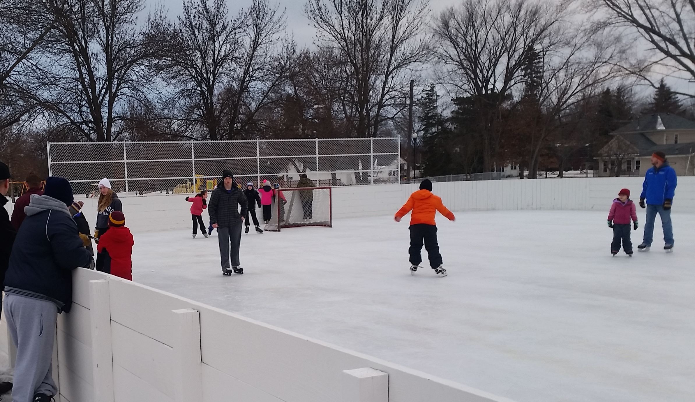 People skating at an outdoor ice rink